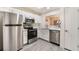 Updated kitchen featuring stainless steel appliances, white cabinets, and granite countertops at 8617 Prairie Hill Dr, Las Vegas, NV 89134