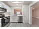 Updated kitchen featuring stainless steel appliances, white cabinets, and wood-look flooring at 8617 Prairie Hill Dr, Las Vegas, NV 89134