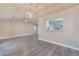 Spacious living room featuring wood-look flooring, vaulted ceilings, and an elegant chandelier at 8617 Prairie Hill Dr, Las Vegas, NV 89134