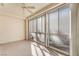 Inviting carpeted sun room with multiple windows, ceiling fan and textured walls at 8617 Prairie Hill Dr, Las Vegas, NV 89134