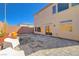 Spacious backyard with a paved patio, modern seating, and mature landscaping at 8749 Black Cordon Rd, Las Vegas, NV 89139