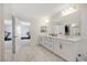 Modern bathroom with double vanity and a large mirror at 8749 Black Cordon Rd, Las Vegas, NV 89139