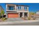 Two-story house with orange garage door and landscaped yard at 8749 Black Cordon Rd, Las Vegas, NV 89139