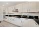 Contemporary kitchen with white cabinets, stainless steel appliances and dark countertops at 8749 Black Cordon Rd, Las Vegas, NV 89139