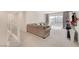 Bright living room with sliding glass doors to balcony, plush carpeting, and a comfortable sectional sofa at 8749 Black Cordon Rd, Las Vegas, NV 89139