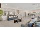 Open concept living area with kitchen, staircase and comfortable seating at 8749 Black Cordon Rd, Las Vegas, NV 89139