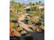 Landscaped walking path with pond and upscale homes in the background at 8913 Canyon Springs Dr, Las Vegas, NV 89117