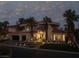 Luxury home with palm trees and elegant landscaping at night at 8913 Canyon Springs Dr, Las Vegas, NV 89117