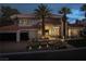 Luxury home with palm trees and elegant landscaping at night at 8913 Canyon Springs Dr, Las Vegas, NV 89117