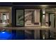 Luxury pool with interior view of modern home at night at 8913 Canyon Springs Dr, Las Vegas, NV 89117