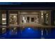 Stunning pool at night with interior view of the home at 8913 Canyon Springs Dr, Las Vegas, NV 89117