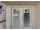 White double doors leading to a back patio, with mini blinds at 8945 Clairton Ct, Las Vegas, NV 89117