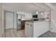 Kitchen features stainless steel fridge and white cabinets at 8945 Clairton Ct, Las Vegas, NV 89117