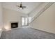 Living room with gray carpet, fireplace, and access to patio at 8945 Clairton Ct, Las Vegas, NV 89117