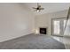 Living room with gray carpet, fireplace, and access to patio at 8945 Clairton Ct, Las Vegas, NV 89117