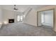 Living room with gray carpet, fireplace, and patio access at 8945 Clairton Ct, Las Vegas, NV 89117