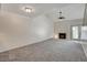 Living room with gray carpet, fireplace, and ceiling fan at 8945 Clairton Ct, Las Vegas, NV 89117