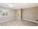 Bright bedroom with wood-look floors, en-suite bathroom, and plantation shutters at 9113 Harvest Homes St, Las Vegas, NV 89123