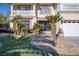 Landscaped front yard with palm trees and rock at 9113 Harvest Homes St, Las Vegas, NV 89123