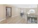 Upstairs hallway with wood-look floors and elegant chandelier at 9113 Harvest Homes St, Las Vegas, NV 89123