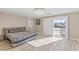 Main bedroom with king-size bed, sliding doors to balcony, and chandelier at 9113 Harvest Homes St, Las Vegas, NV 89123