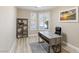 Bright home office with wood-look floors, large window, and built-in shelving at 9113 Harvest Homes St, Las Vegas, NV 89123