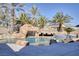 Resort-style pool with a waterfall and tiki bar at 9113 Harvest Homes St, Las Vegas, NV 89123