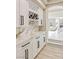 Elegant wet bar features white shaker cabinets, marble countertops, and wine rack at 9113 Harvest Homes St, Las Vegas, NV 89123