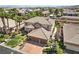 An aerial view showcasing a two-story house with a three-car garage and palm trees at 9523 Castillana Ct, Las Vegas, NV 89147