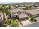 Aerial view of a two-story house with a three-car garage and manicured lawn at 9523 Castillana Ct, Las Vegas, NV 89147