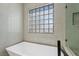 Bathroom with free-standing bathtub and glass block window at 9523 Castillana Ct, Las Vegas, NV 89147