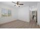 Bright bedroom with wood-look floors, plantation shutters, and ceiling fan at 9523 Castillana Ct, Las Vegas, NV 89147