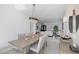 Modern dining room with chandelier and view into the living room at 9523 Castillana Ct, Las Vegas, NV 89147