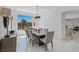 Spacious dining room features a wood table, chandelier, and access to the backyard at 9523 Castillana Ct, Las Vegas, NV 89147