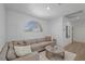 Light and airy sitting area with a sectional sofa and wood floors at 9523 Castillana Ct, Las Vegas, NV 89147