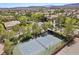 Community tennis court surrounded by palm trees and homes at 9523 Castillana Ct, Las Vegas, NV 89147