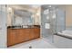 Large bathroom with double sinks, a soaking tub and a walk-in shower at 135 E Harmon Ave # 2701&2703, Las Vegas, NV 89109