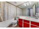 Clean bathroom with a red vanity, bathtub, and shower at 1431 Di Blasi Dr # 105, Las Vegas, NV 89119
