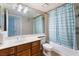 Clean bathroom with wood vanity and striped shower curtain at 1431 Di Blasi Dr # 105, Las Vegas, NV 89119