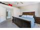 Large bedroom with a dark wood sleigh bed and ceiling fan at 1431 Di Blasi Dr # 105, Las Vegas, NV 89119