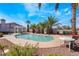 Community pool with palm trees and seating area at 1431 Di Blasi Dr # 105, Las Vegas, NV 89119