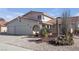 Two-story house with a three-car garage and desert landscaping at 1505 Frandosa Ln, Las Vegas, NV 89117