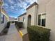 Front entrance with walkway, landscaping, and stucco exterior at 2148 Pebble Creek Ln, Laughlin, NV 89029