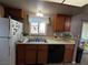 Kitchen features double sink, dishwasher, and stained wood cabinets at 2148 Pebble Creek Ln, Laughlin, NV 89029