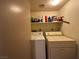 Laundry room with washer, dryer, and shelving for storage at 2148 Pebble Creek Ln, Laughlin, NV 89029