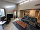 Living room with fireplace, large windows, and comfortable seating at 2148 Pebble Creek Ln, Laughlin, NV 89029