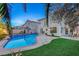 Home with sparkling pool, grassy lawn, and patio at 2430 Antler Point Dr, Henderson, NV 89074