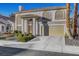 Two-story house with a large garage and manicured landscaping at 2430 Antler Point Dr, Henderson, NV 89074