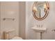 Powder room featuring pedestal sink, decorative mirror, sconces and neutral walls at 2455 W Serene Ave # 640, Las Vegas, NV 89123