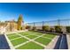 Landscaped backyard with artificial turf and sitting area at 270 Besame Ct, Las Vegas, NV 89138